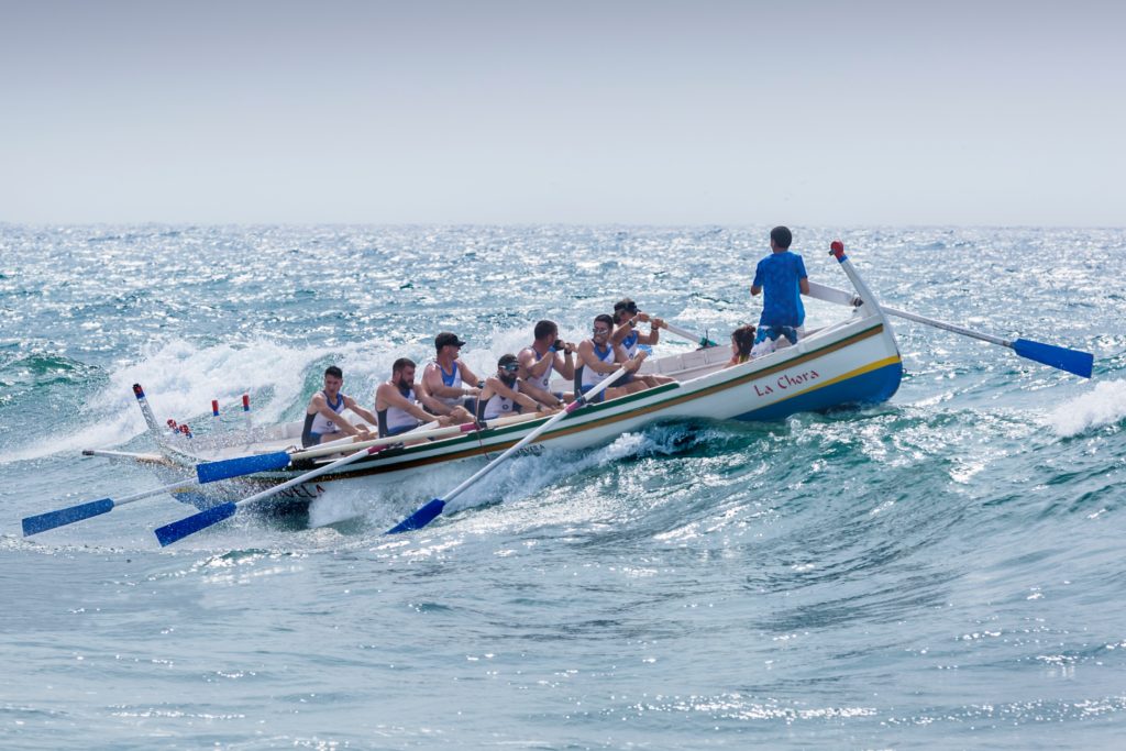 A team riding a boat with there leader