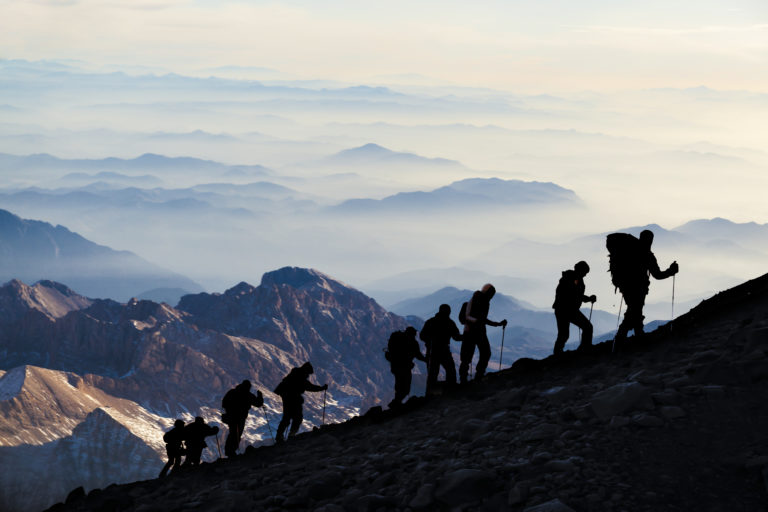Hikers forming like a chain in the top of the mountain